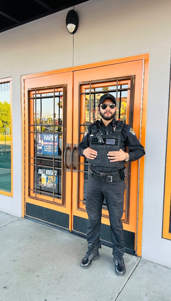 Guard For America officer standing at a storefront entrance