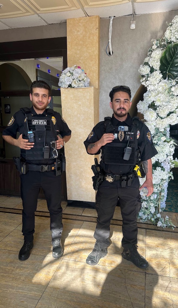 Two Guard For America officers standing post at an indoor event
