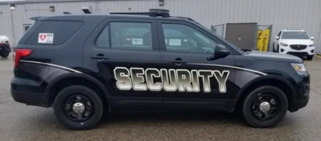 Marked security SUV with security lettering on the door