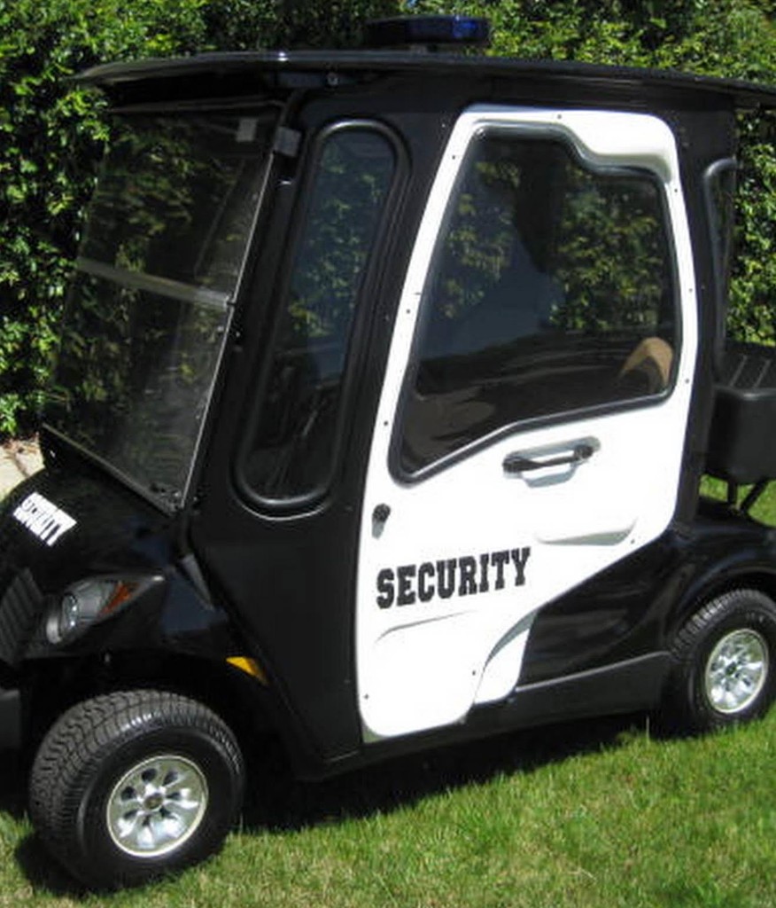 Black and white security golf cart marked for property patrol